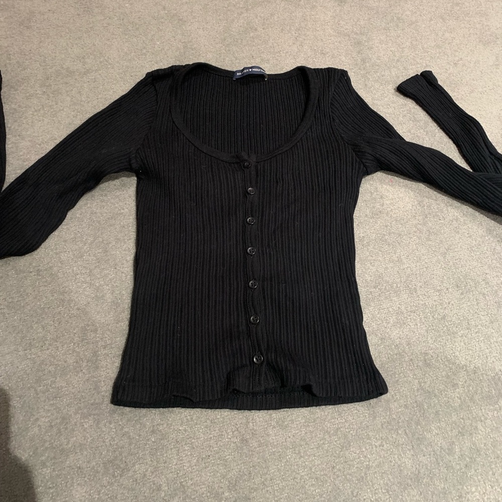 Ribbed black brandy Melville long sleeve button top. Never wore. One size.